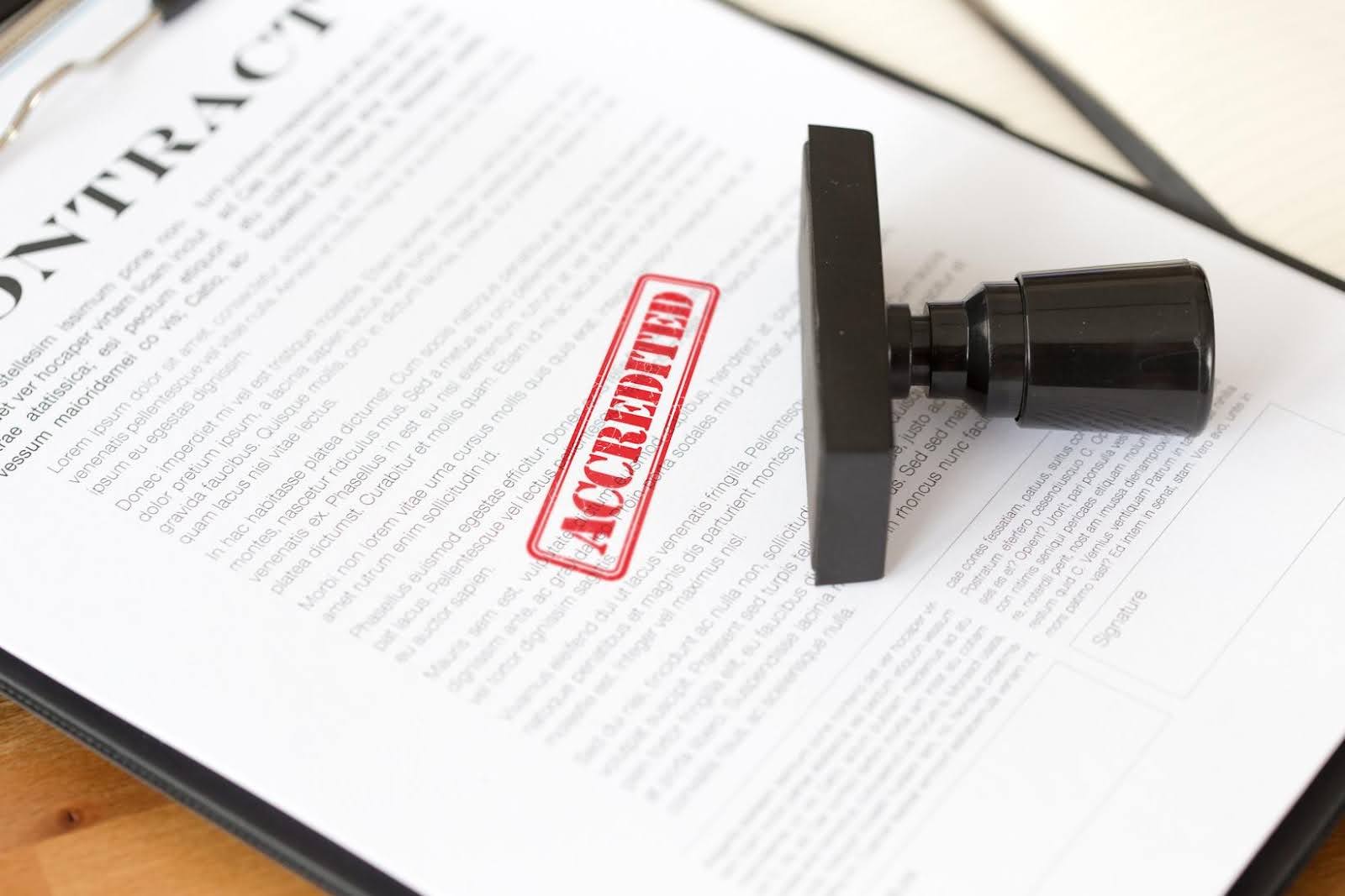 Accrediting document stamped with approval, representing the certification standards required for disability service providers and agencies.