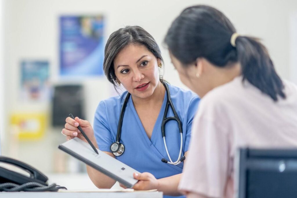 IDPH home care survey explained with nurse reviewing compliance documents with caregiver during inspection preparation