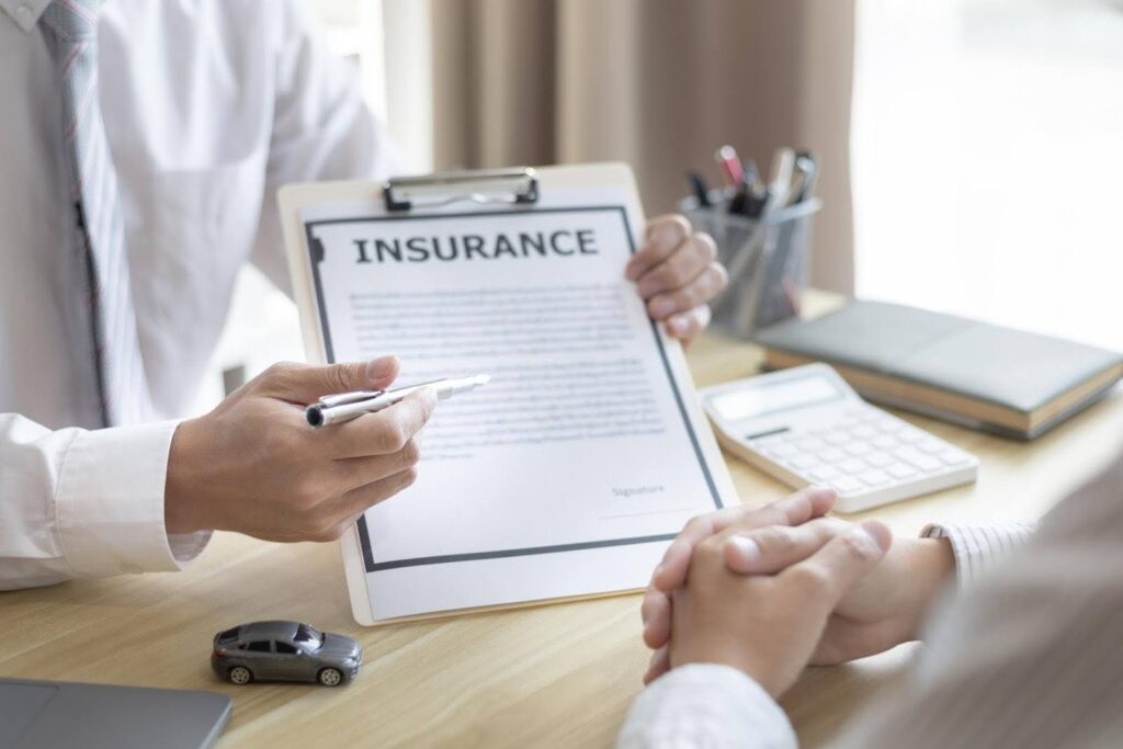 CTK Advisors explaining required Insurance coverage during the licensing process, with a consultant reviewing policy documents before approval.