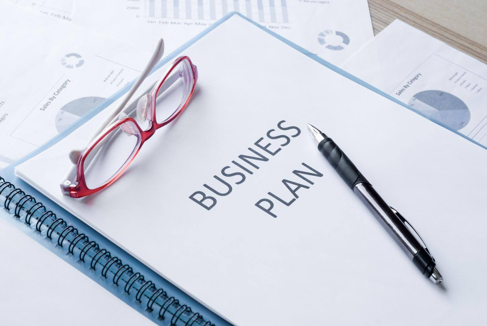 CTK Advisors supporting healthcare entrepreneurs with a detailed business plan for a healthcare license application, shown through organized documents, financial charts, and planning materials on a desk.