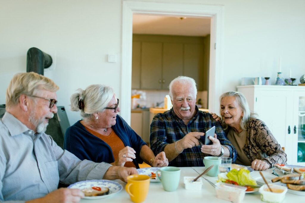 Group of seniors gathered at a table reviewing information together, symbolizing compliance preparation and successful audit support from CTK Advisors for CILA providers.
