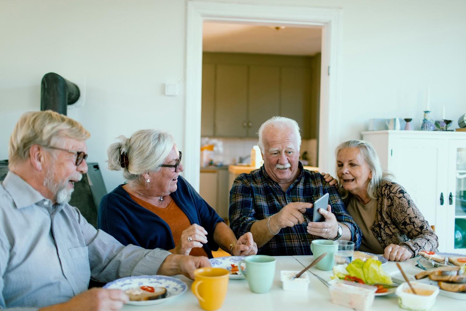 Group of seniors gathered at a table reviewing information together, symbolizing compliance preparation and successful audit support from CTK Advisors for CILA providers.