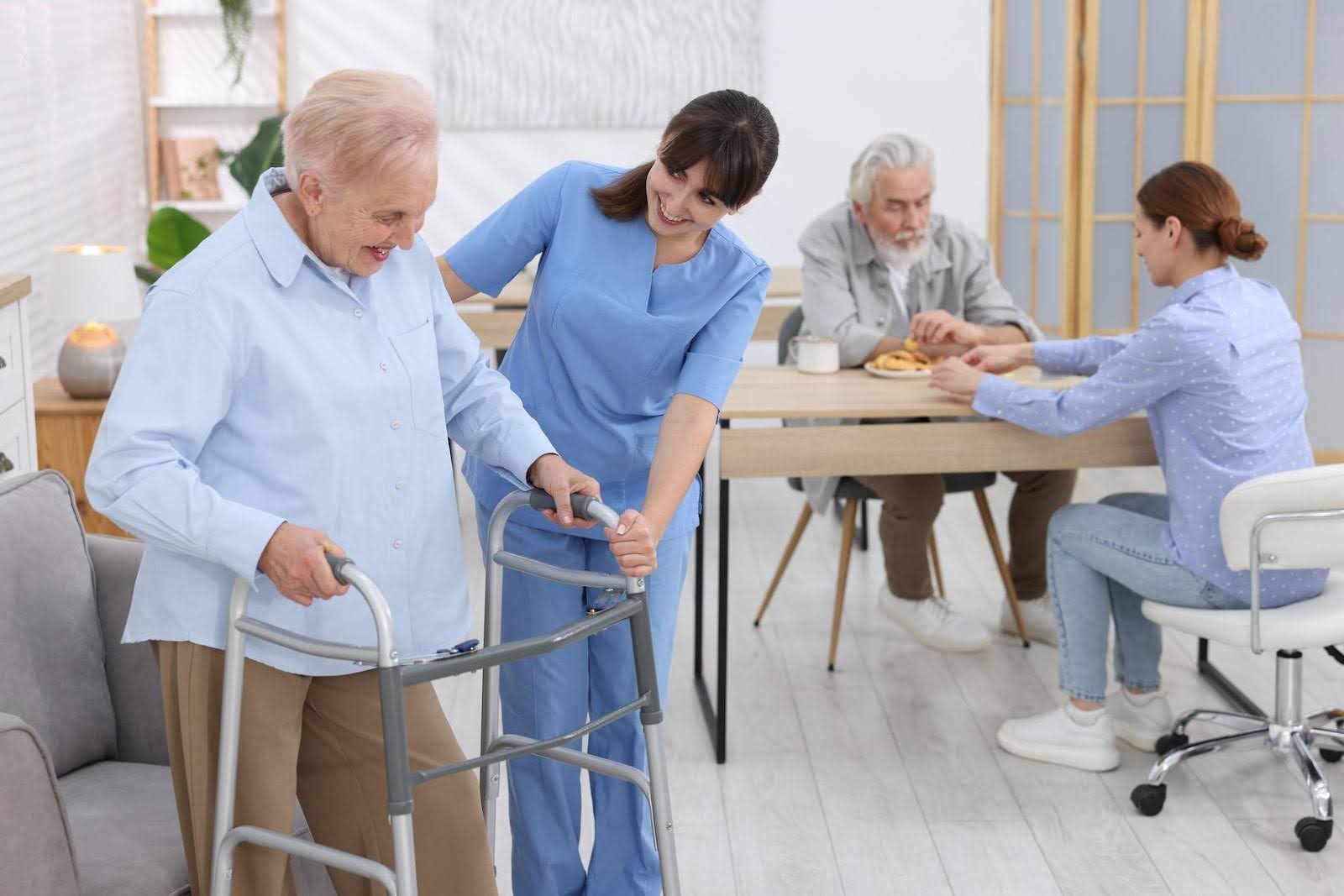 Caregiver assisting a senior with a walker while others receive care in a home setting, representing Ethical considerations in home health care consulting by CTK Advisors.