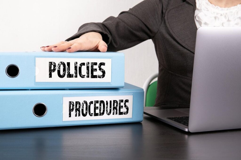 Organized binders labeled policies and procedures on a desk, representing healthcare SOPs development and compliance guidance provided by CTK Advisors.