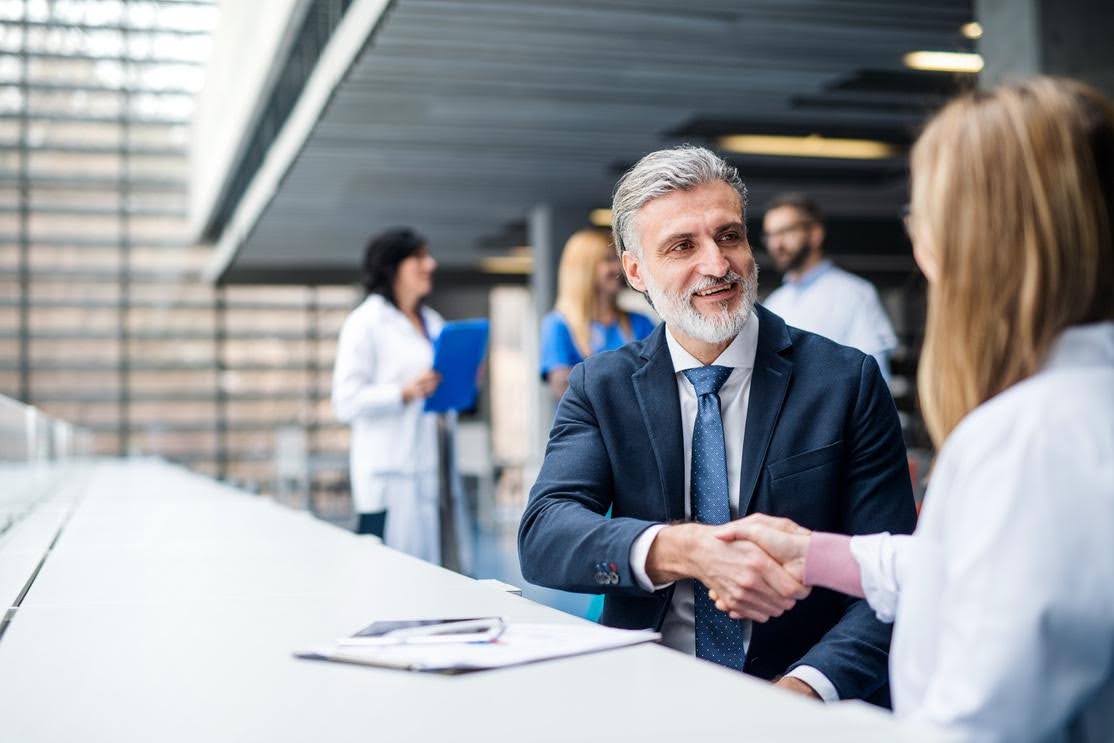 Healthcare business owner meeting with a professional while awaiting license approval for CTK Advisors.