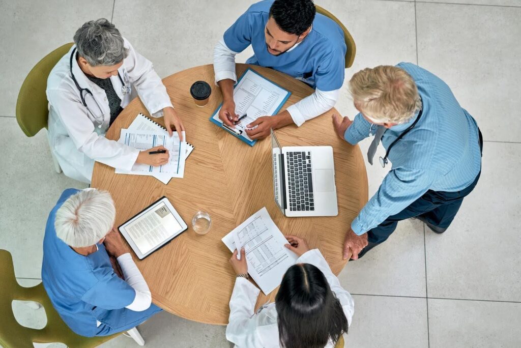 **SEO-Optimized Alt Text:** “Healthcare professionals reviewing application documents and requirements after a healthcare license application stalls, with guidance from CTK Advisors.”