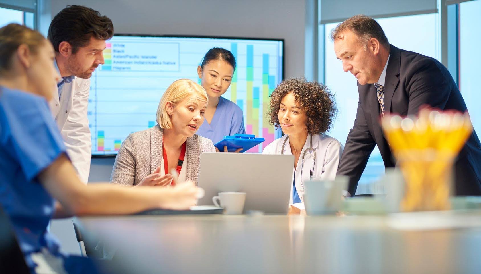 Healthcare professionals assisting an older adult, highlighting the importance of verifying a healthcare business location before opening with CTK Advisors.
