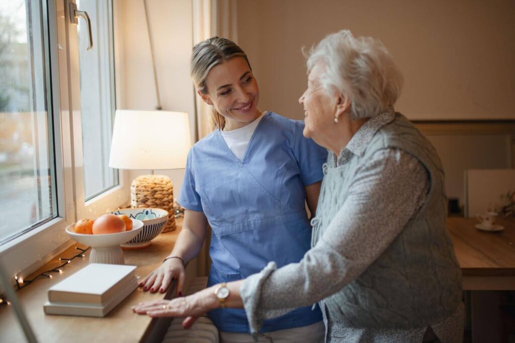 Healthcare professional providing support to an older adult as CTK Advisors helps healthcare businesses strengthen compliance.